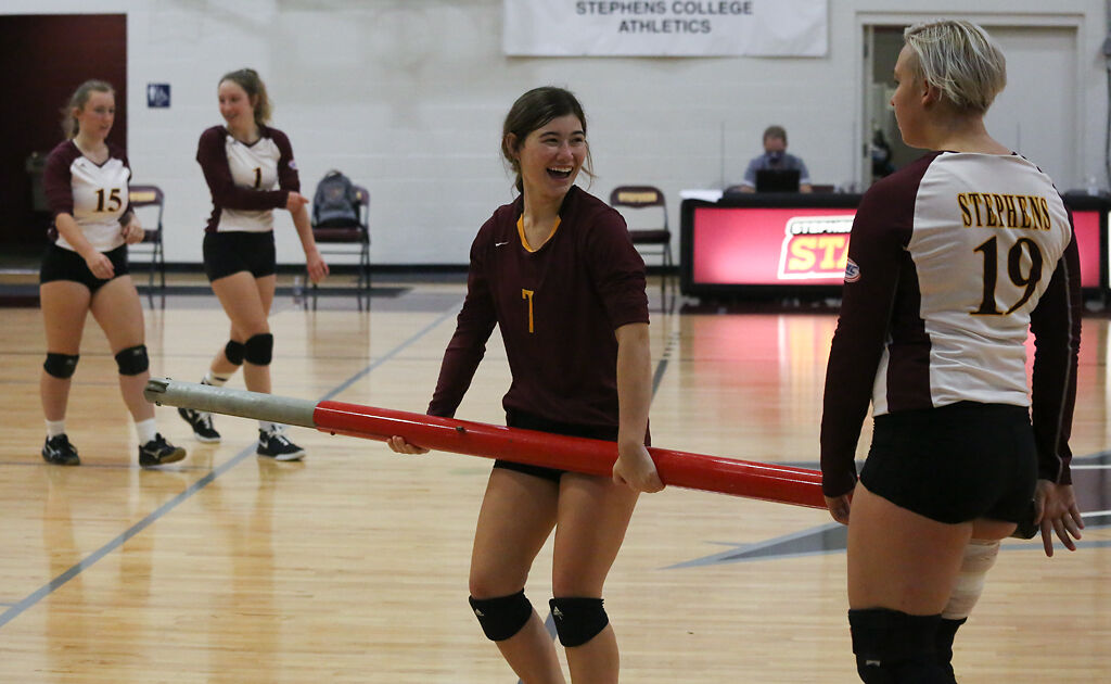 Stephens College sophomore Mollie Thompson, center, takes down the net after a game